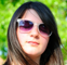 A young woman wearing sunglasses.