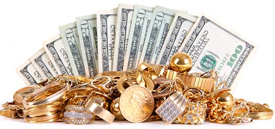 A fan of cash begind a pile of gold jewelry and coins. Cash for gold San Francisco.